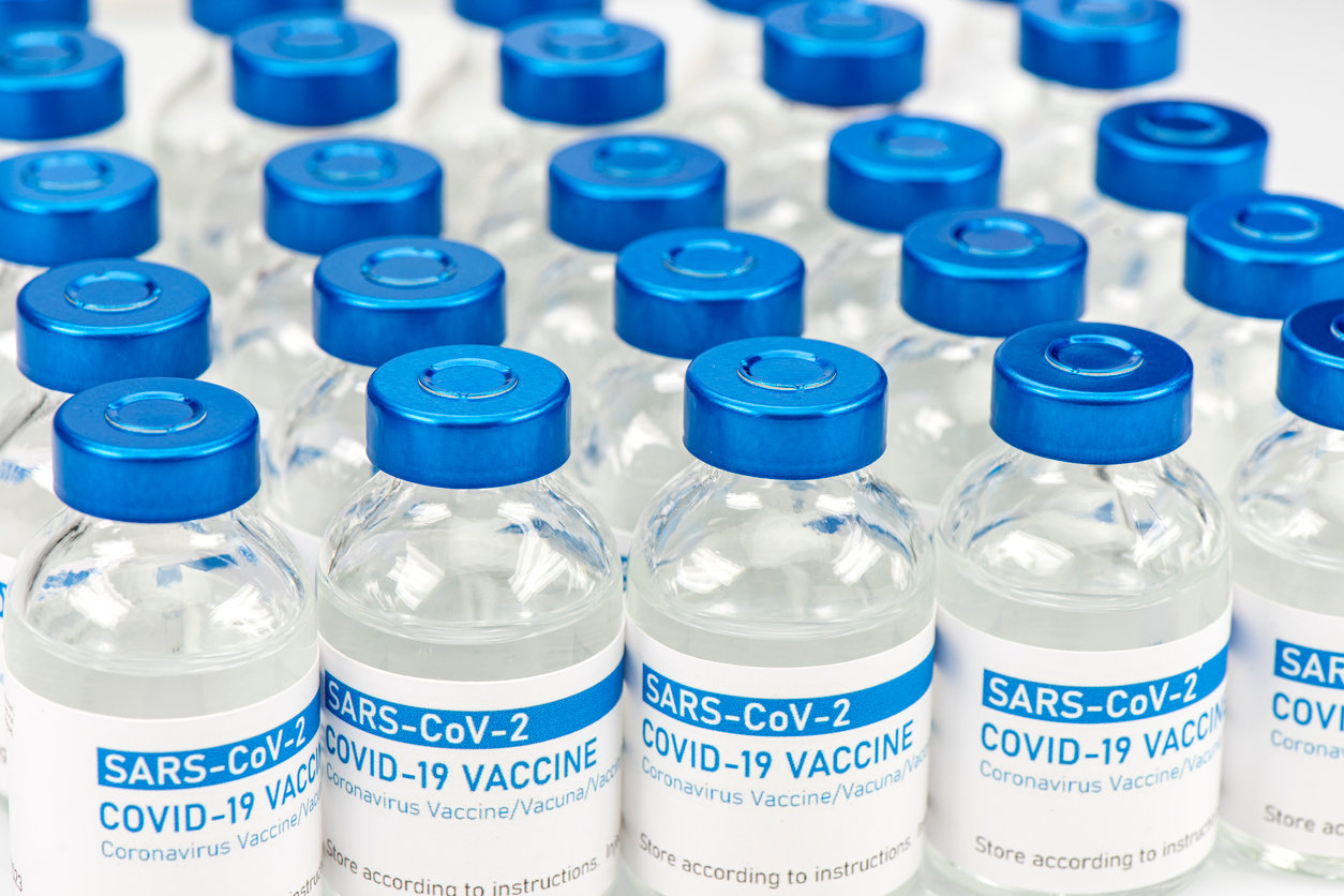 Closeup of a long row of vials with COVID-19 (coronavirus) vaccine.