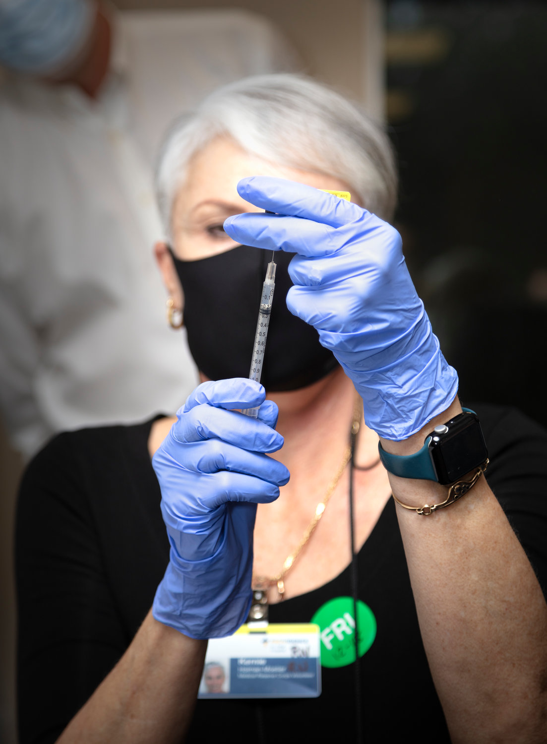 Kernie Moeller, nurse from the Thurston County Medical Reserve Corps, draws the first COVID-19 vaccination Dec. 18, 2020, as vaccinators from Providence Southwest Washington began administering the vaccine.