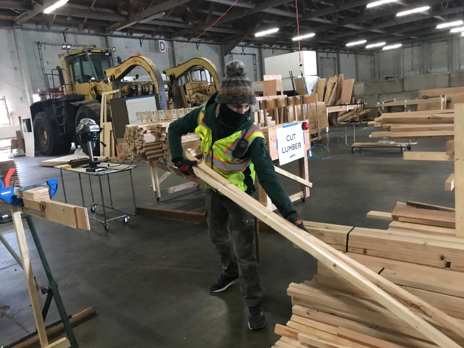 Aaron Sauerhoff, demonstrating steps of constructing a temporary shelter at a shop at the Port of Olympia on Feb. 25, 2021.