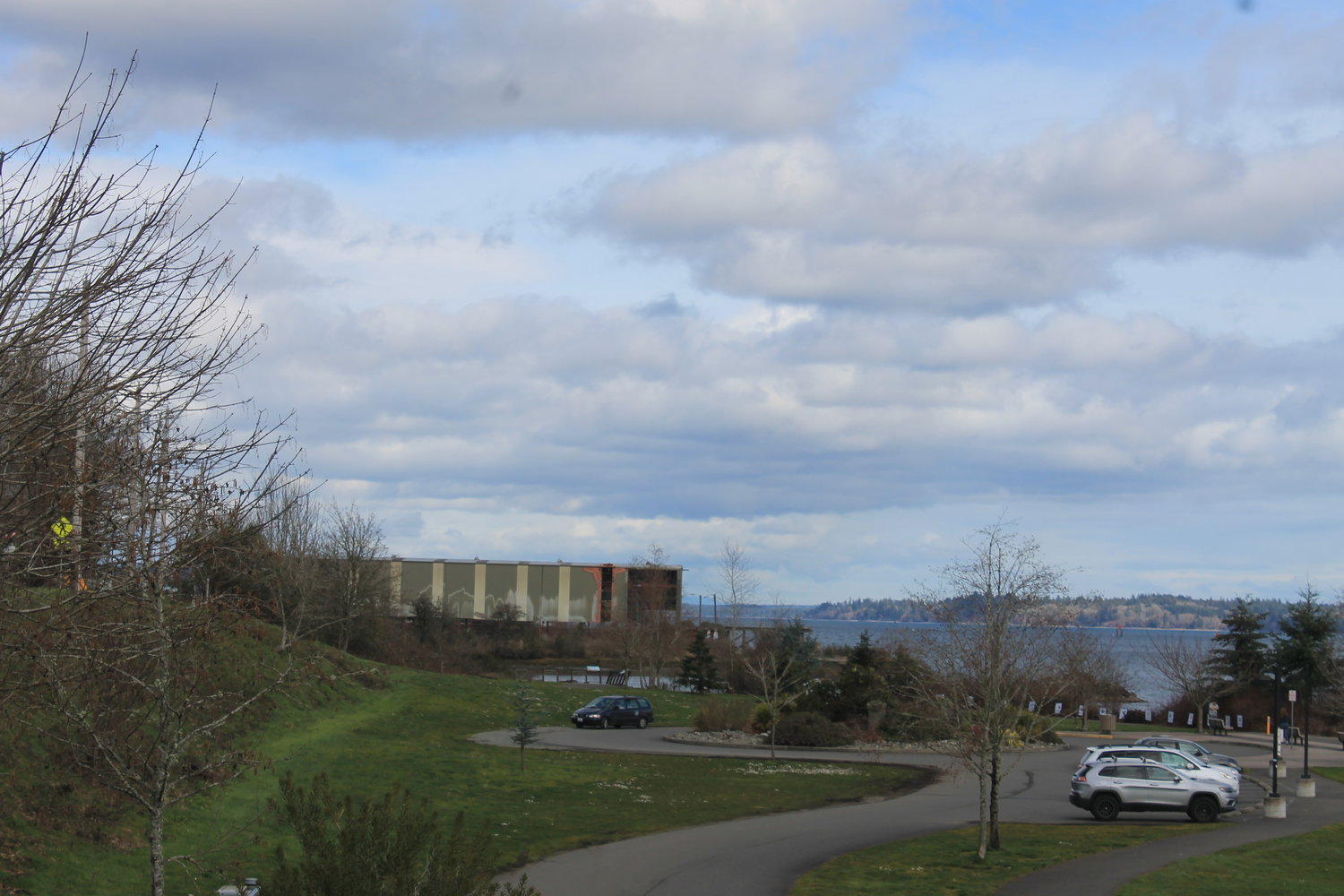 This is a north-facing view of the property on which a developer is proposing to construct five mixed-use buildings and parking. The location is on West Bay Drive in west Olympia. The park, partly shown in the photo, would not be affected by the new development other than to extend the walking path north.