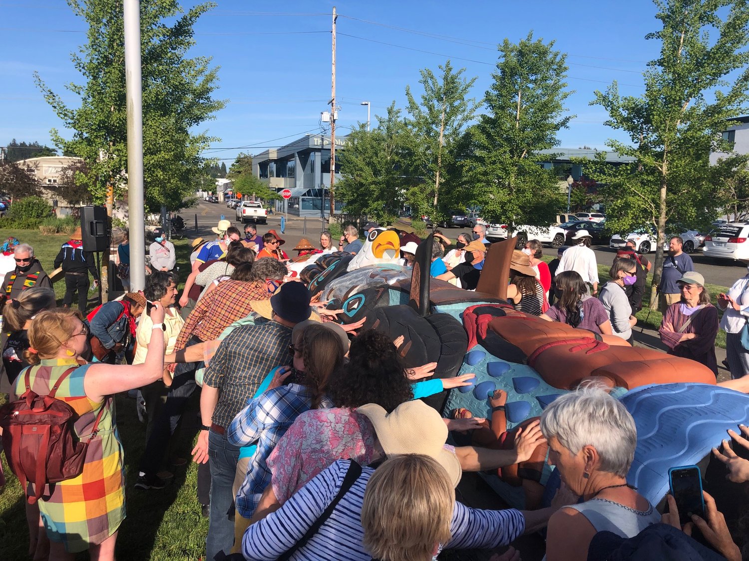 Dozens of people were able to touch the new totem pole during a dedication blessing in Olympia on May 15, 2021.