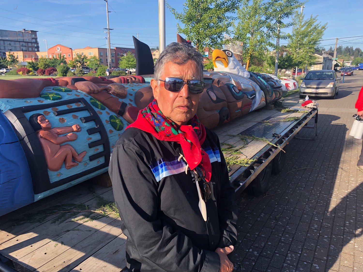 Douglas James, one of the lead carvers in the House of Tears Carvers of the Lummi Nation, standing in front of the totem pole that will travel to Washington, D.C. during the summer of 2021, in Olympia on May 15, 2021.