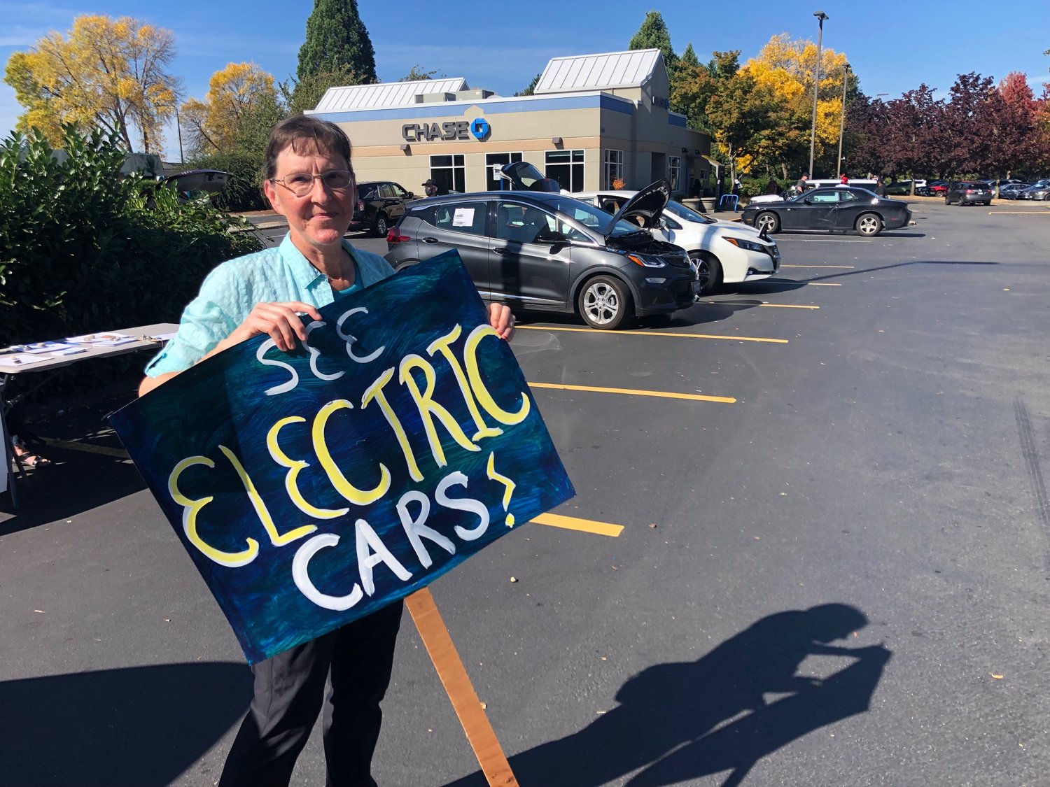 Karen Messmer of Olympia, a volunteer with Thurston Climate Action Team, campaigned for electric cars at Thurston Climate Action Team's flash mob gathering on Sat., Sept. 25, 2021.