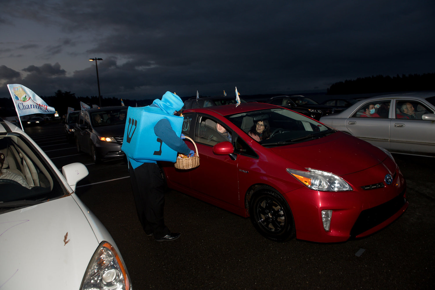 The Dreidel Man traveled from car to car giving chocolate "gelt" candy to participants at the 2020 Chanukah menorah lighting at the Swantown Marina parking lot.
