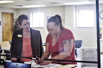 Netalie Mercado, military spouse, speaks with Holly Nusom in July at the Spouse Employment Center at Fort Campbell, Kentucky. A permanent change of station, or PCS, is something most spouses will experience during their time married to a service member.