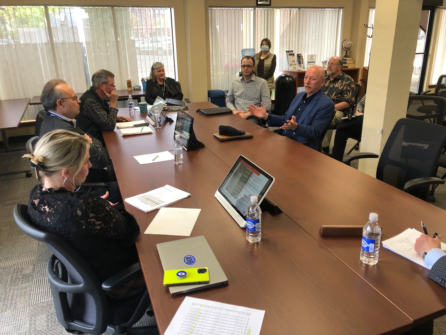 Seated around the conference table are, l-r, Port Commissioners Amy Evans, Bob Iyall, Joe Downing, executive director Sam Gibboney, Thomas Architecture Studios’ Amos Callender and Ron Thomas.