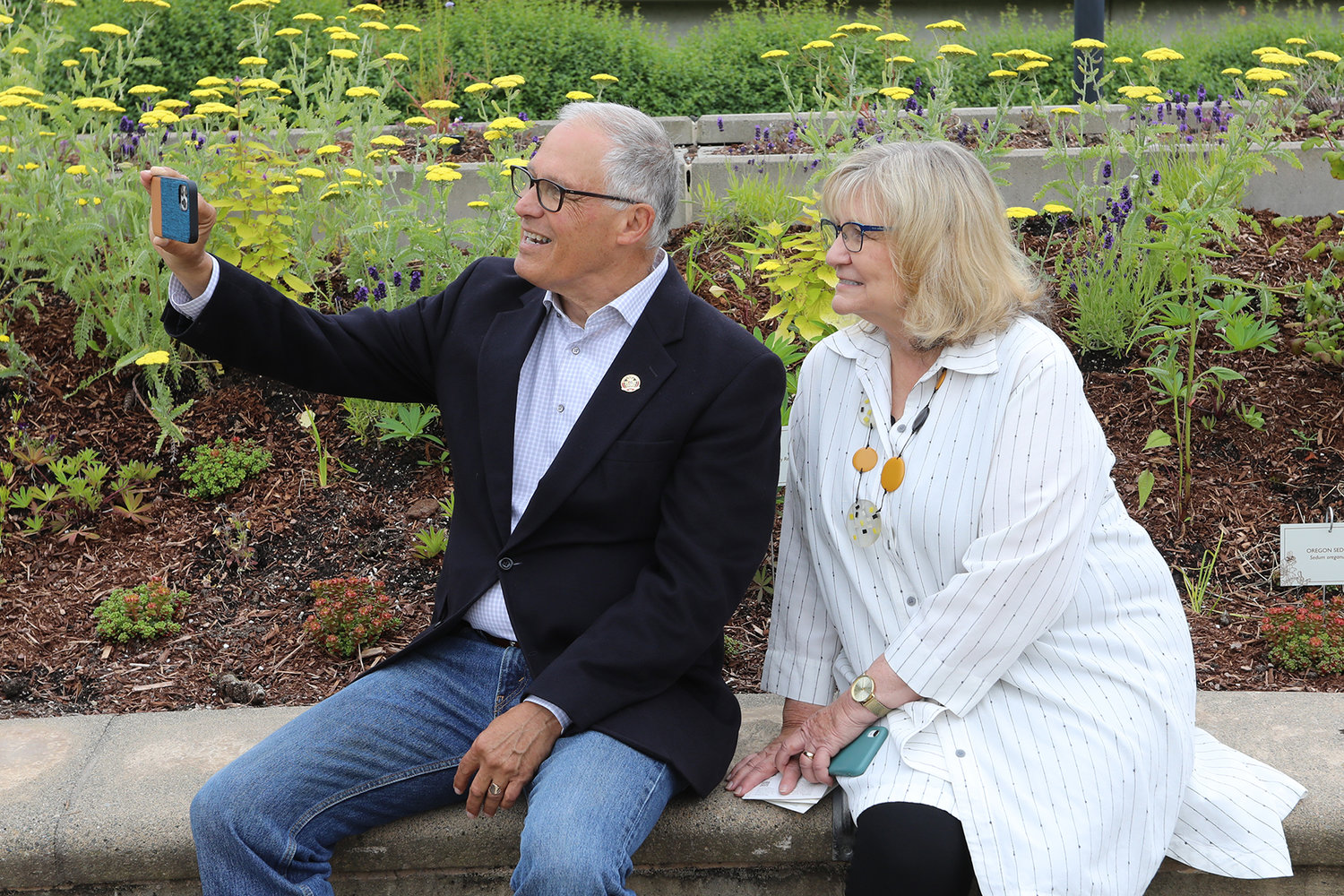 Governor Jay Inslee shoots a selfie with his wife, Trudi, at the formal opening of the Capitol Campus Pollinator Garden on June 22, 2022.