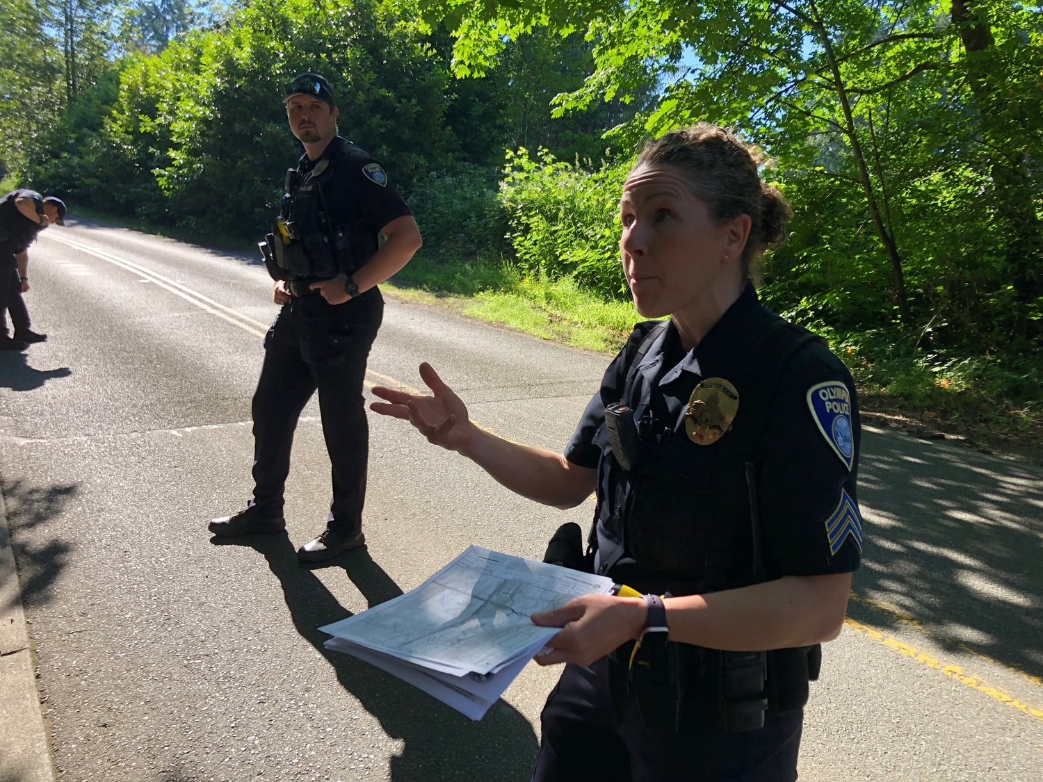 Sgt S. Parker explains  about the city of Olympia's jurisdiction over the logging and the safety barriers near the logging operation on June 27, 2022.