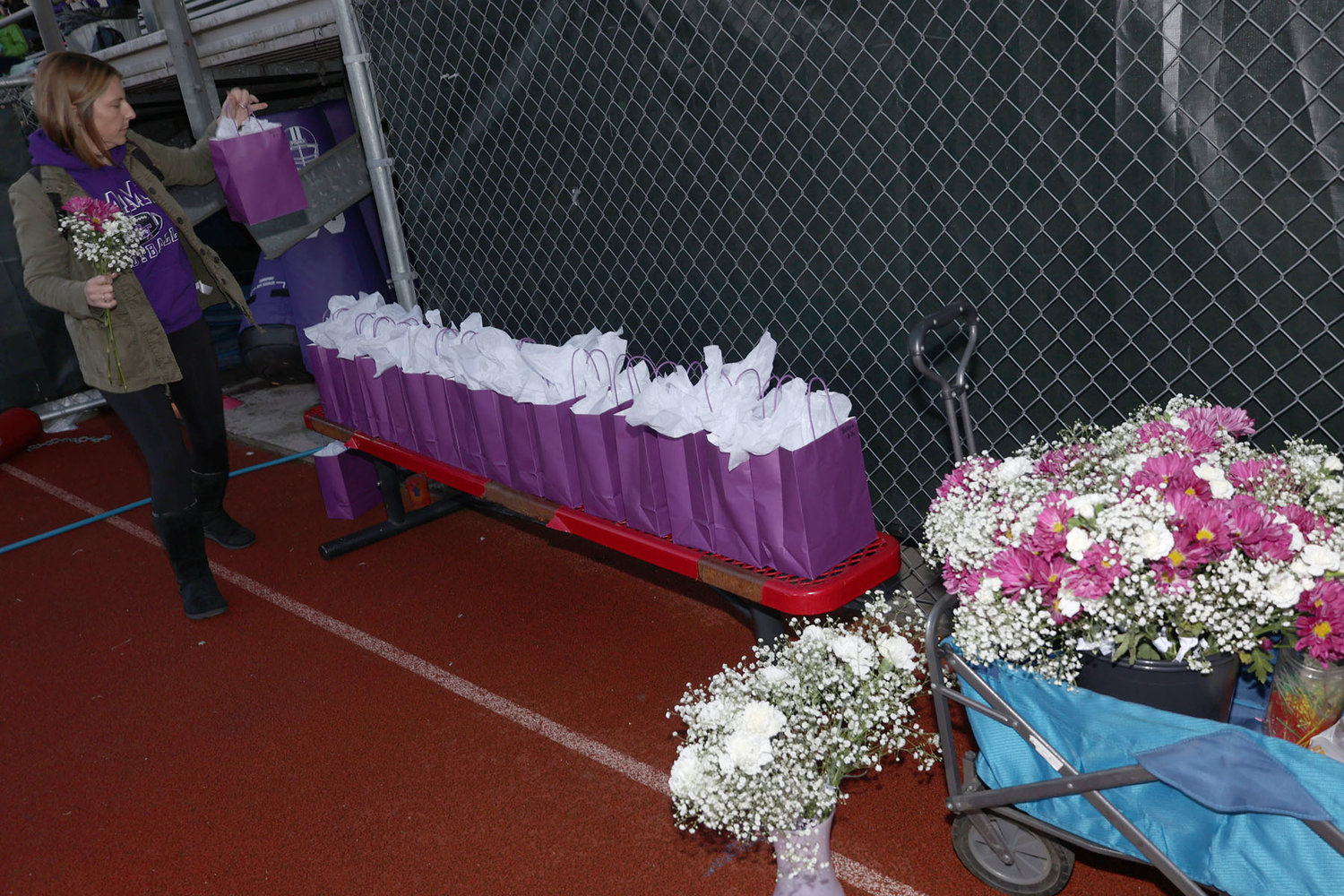 A volunteer lines goodie bags and flowers for the North Thurston High School parents to give to their kids.