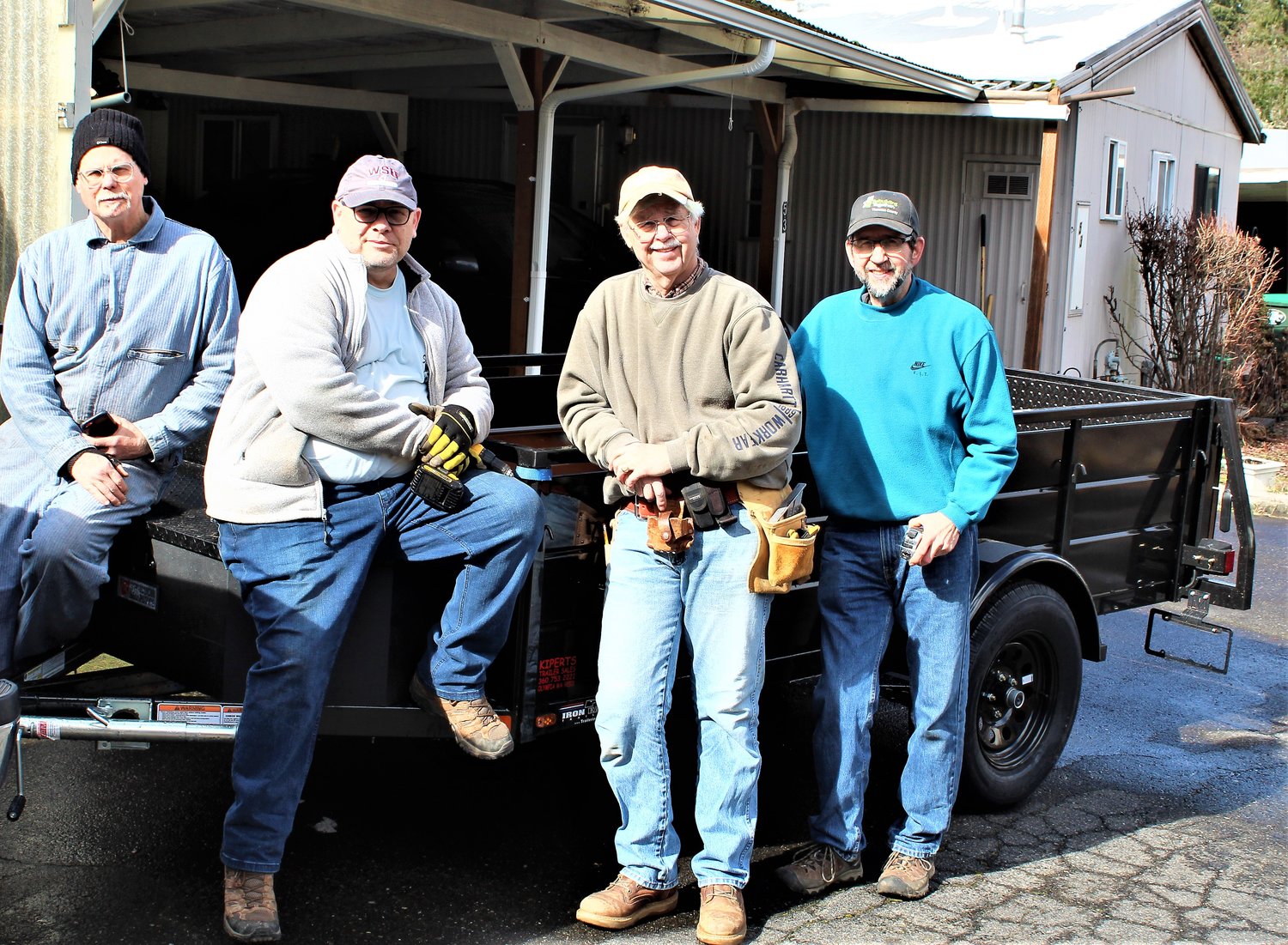 (L to R) Paul Knox, Stu Hemmings, and Steve Barney, with RTTC Project Coordinator Bruce in front of the trailer donated by Olympia Rotary.