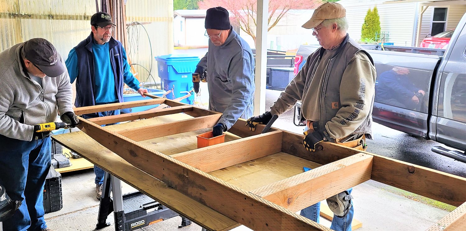 It’s all hands on deck as Olympian Rotarians work on a wheelchair ramp for Del and Carol in Tumwater.